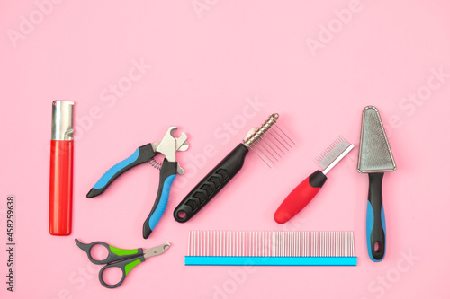 pet care and grooming tools on a pink background.