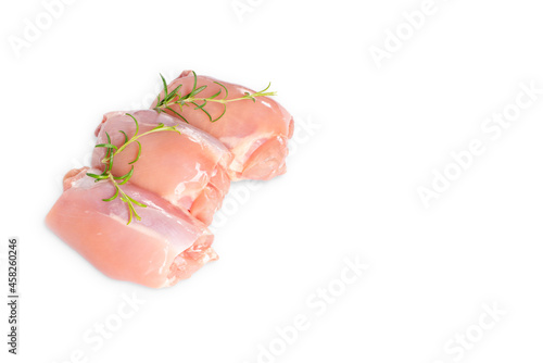 Raw chicken thigh meat without bone and without skin with rosemary leaves on a white background isolade.