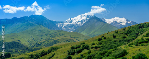 Mountains of North Ossetia, beautiful summer landscapes with blue sky and clouds. © Michael