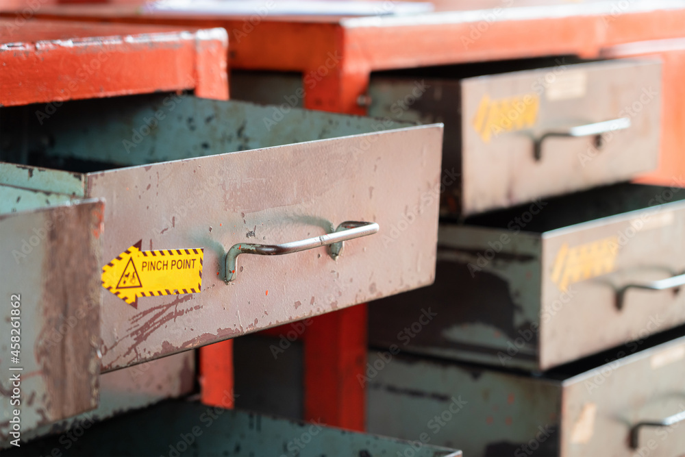 Metal drawer shelf box for keep the hand tool equipment in factory storage inventory room. Industrial object photo. Close-up and selective focus at the handle part. Metal drawer shelf box for keep the hand tool equipment in factory storage inventory room. Industrial object photo. Close-up and selective focus at the handle part.