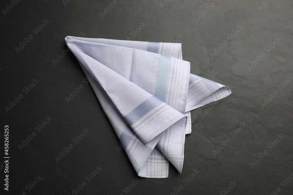 Naklejka premium Handkerchief with pattern on black table, top view