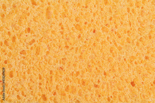 Macro picture of a wet yellow sponge.