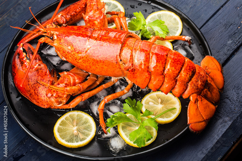 Seafood feast，Lemon and fresh Boston lobster on the ice