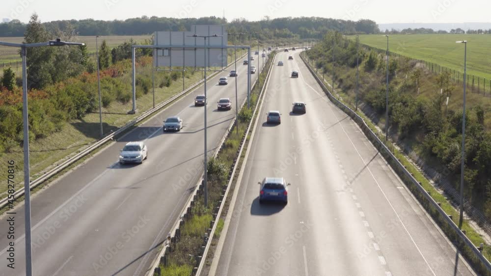 Cars drive on a busy highway in a rural area - top view Cars drive on a busy highway in a rural area - top view