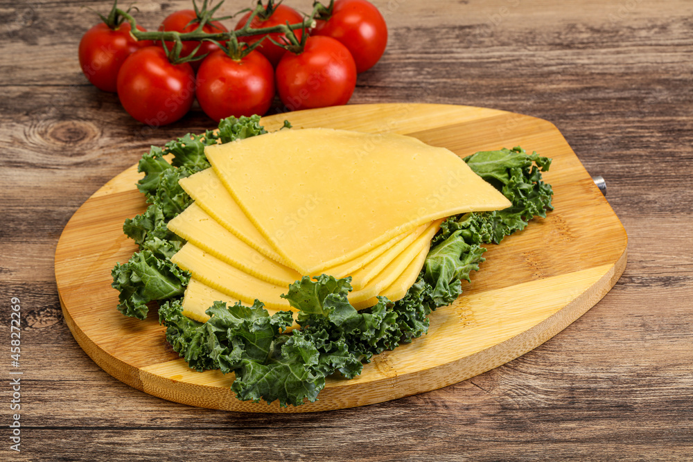 Sliced Gauda cheese over board Sliced Gauda cheese over board