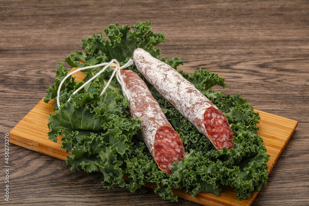 Spanish Fuet sausage with salad leaves Spanish Fuet sausage with salad leaves