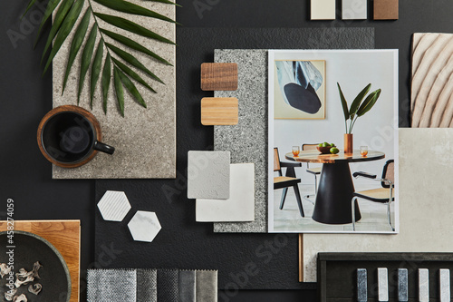 Flat lay composition of creative black architect moodboard with samples of building, textile and natural materials and personal accessories. Top view, black backgroung, template.