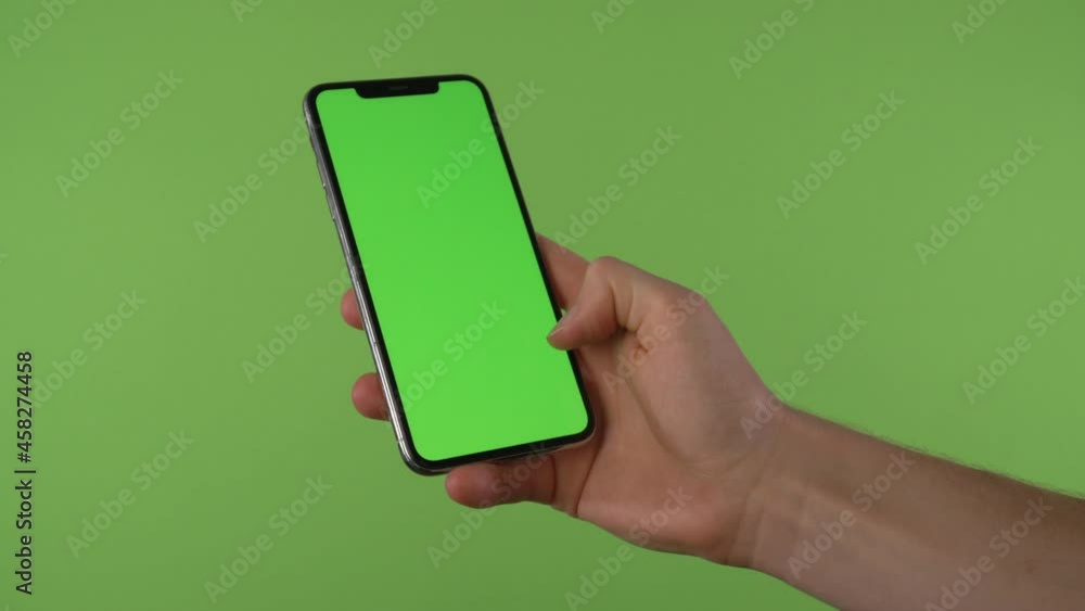 Hand swipes to accept call on phone with chroma green in front of green screen Hand swipes to accept call on phone with chroma green in front of green screen