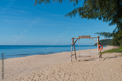 wooden swing on sand beach at Ban Krut beach. travel destination in Prachuap khiri khan, Thailand. summer relax vacation. calm wave sea.