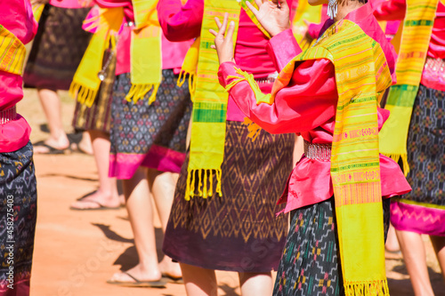 Dancers dressed in bright and colorful local Isaan style costumes