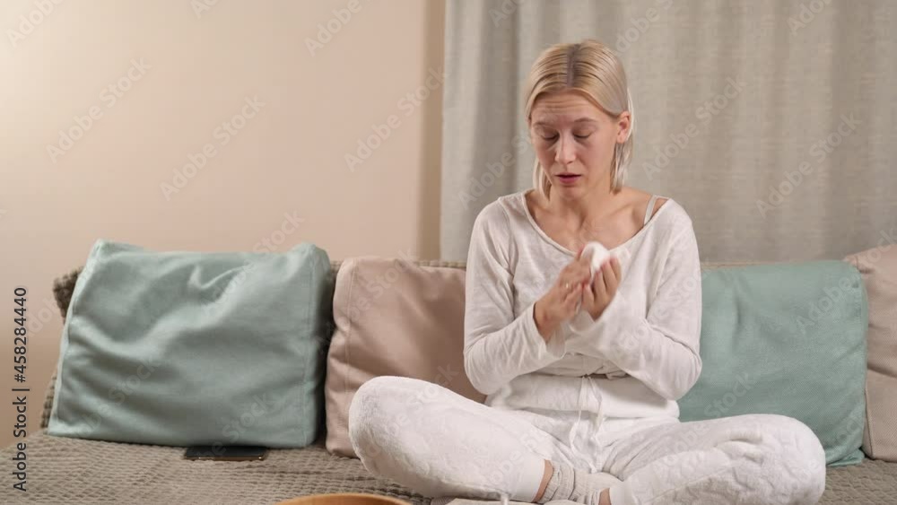 Blonde European Girl Sitting On The Couch Sneezing Blonde European Girl Sitting On The Couch Sneezing