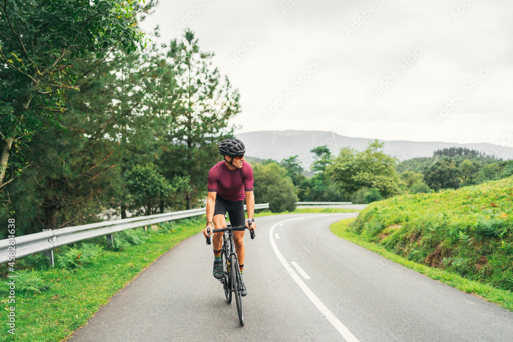 Bicyclist riding bike during training on countryside road Bicyclist riding bike during training on countryside road