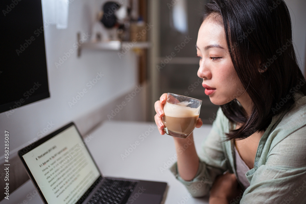Asian writer with laptop and coffee at home Asian writer with laptop and coffee at home