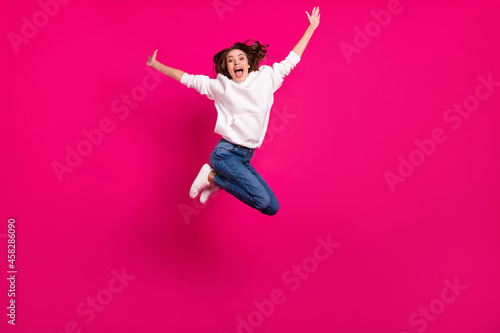 Full size photo of young cheerful girl happy positive smile jumper active sporty isolated over pink color background © deagreez