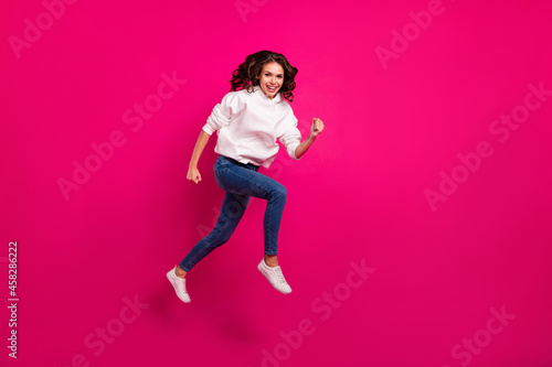 Full length profile side photo of young cheerful girl happy positive smile jumper runner isolated over pink color background