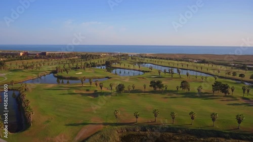 Green golf courses by the sea. Salgados beach. Portugal, Albufeira. Aerial view.