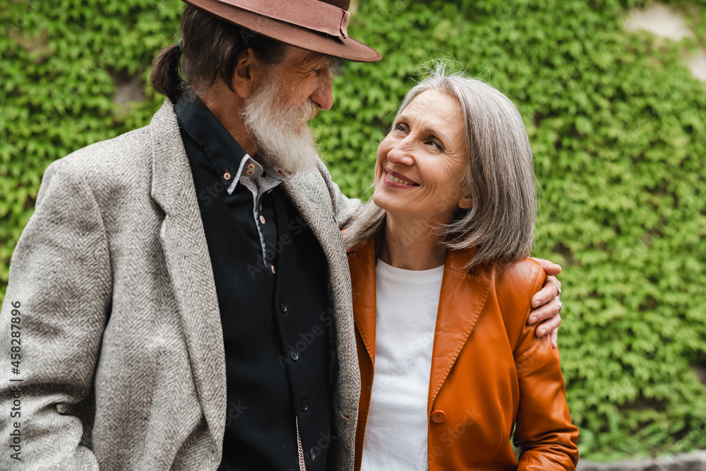 Fototapeta premium White senior couple hugging and smiling to each other
