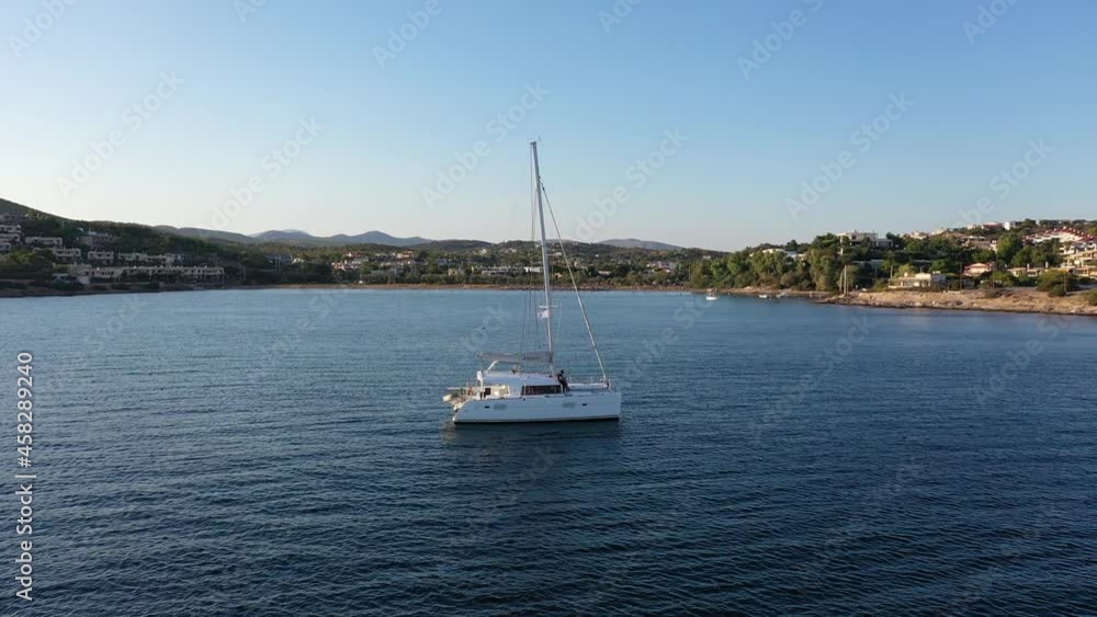 Catamaran sail Yacht anchored on deep blue sea water Catamaran sail Yacht anchored on deep blue sea water