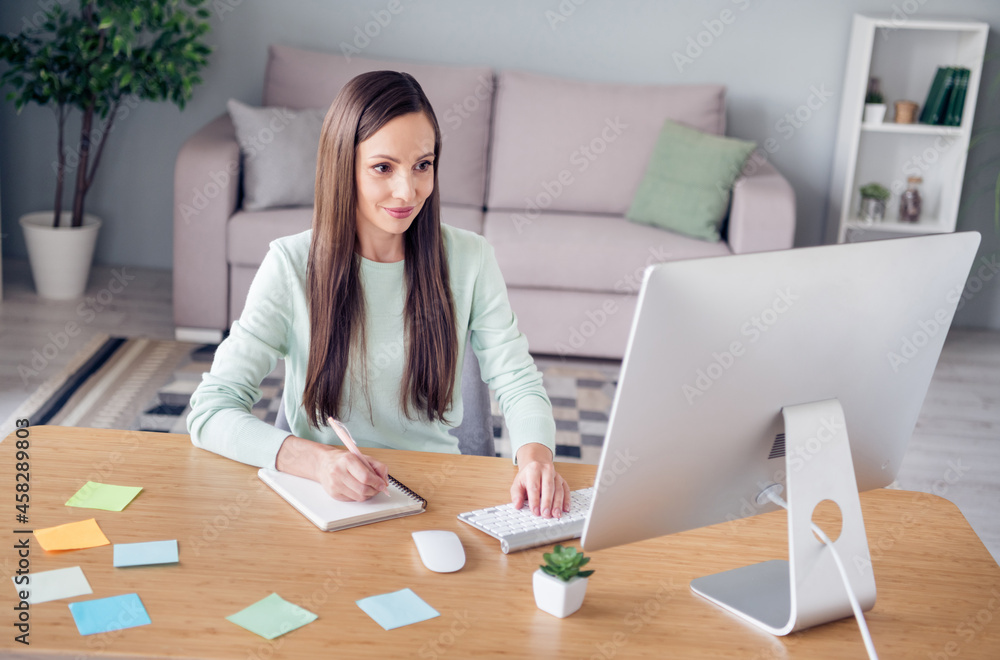 Portrait of attractive cheery focused experienced woman economist finance assistant writing planner staying safe at home indoors Portrait of attractive cheery focused experienced woman economist finance assistant writing planner staying safe at home indoors