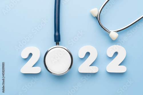 Fotografia, Obraz Stethoscope with 2022 number on blue background