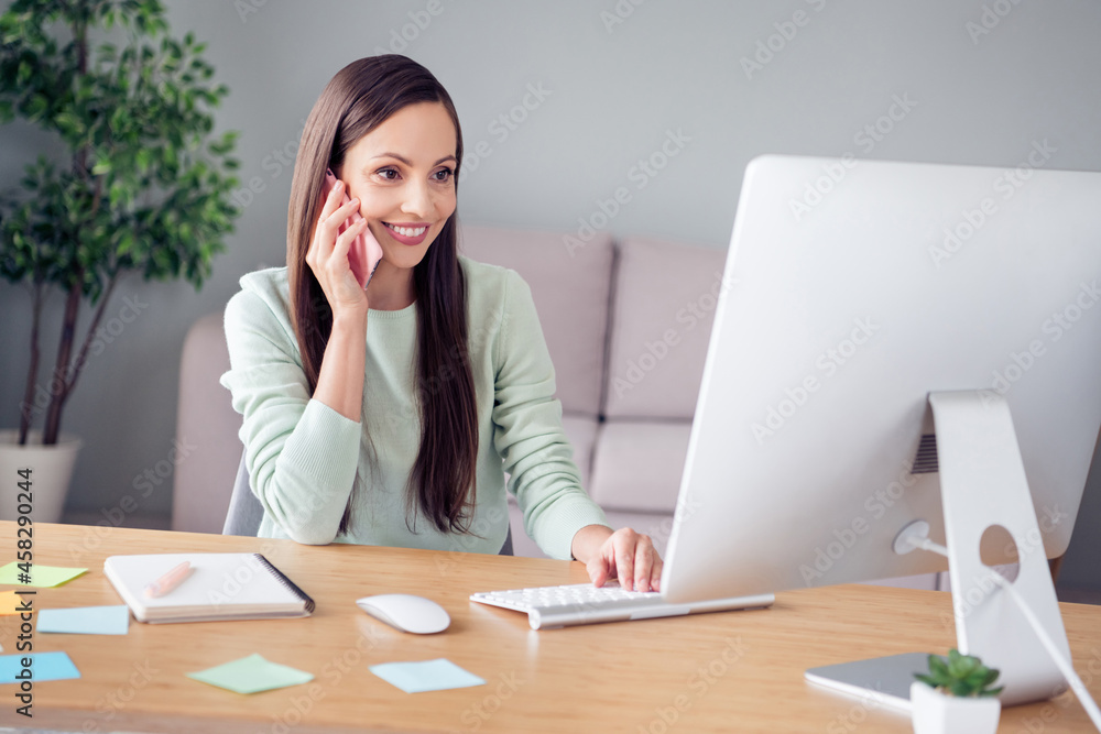Portrait of attractive cheerful successful woman consultant working remotely order service talking on phone at home indoors Portrait of attractive cheerful successful woman consultant working remotely order service talking on phone at home indoors