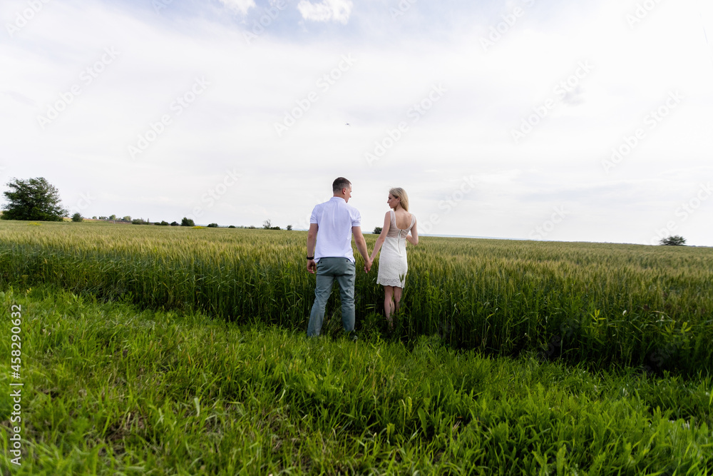 Romantic Couple on a Love Moment at gold wheat field