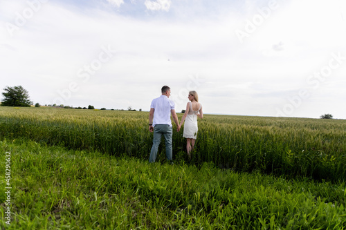 Romantic Couple on a Love Moment at gold wheat field