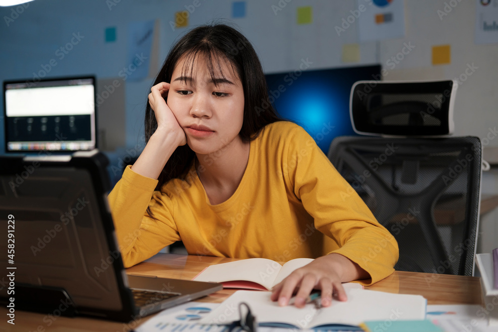 Young woman working on laptop in the office. Young woman working on laptop in the office.