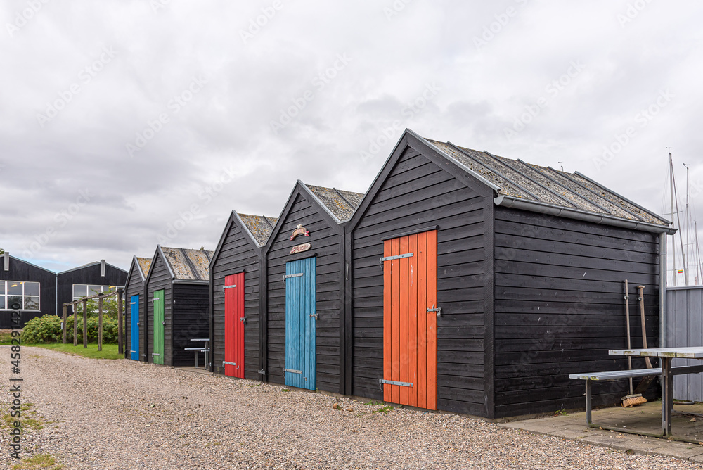 fishermens shacks  lined up with doors in bright colours