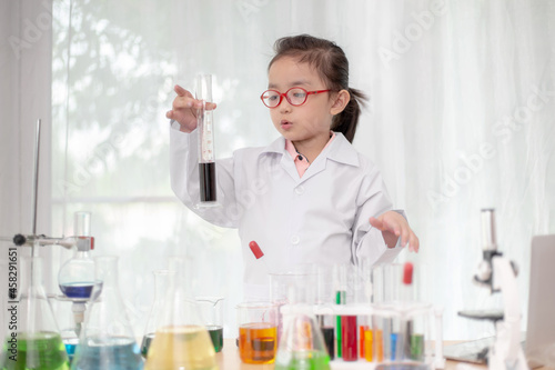 scientist girl with liquid solution in a laboratory