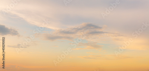 golden sky texture,Beautiful Vivid sky painted by the sun leaving bright golden shades.Dense clouds in twilight sky in winter evening.Evening Vivid sky with clouds.