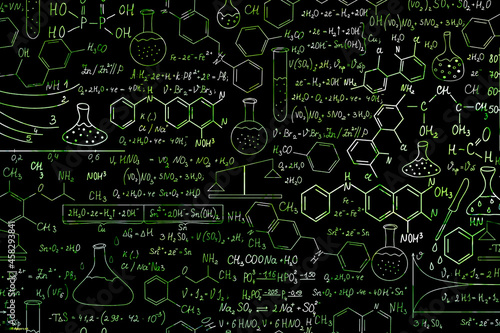 Hand drawn science formulas on chalkboard for background.