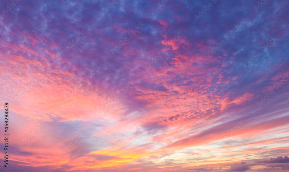 Flaming beautiful sunset background or replacement sky with pinks and organges and yellow and purple