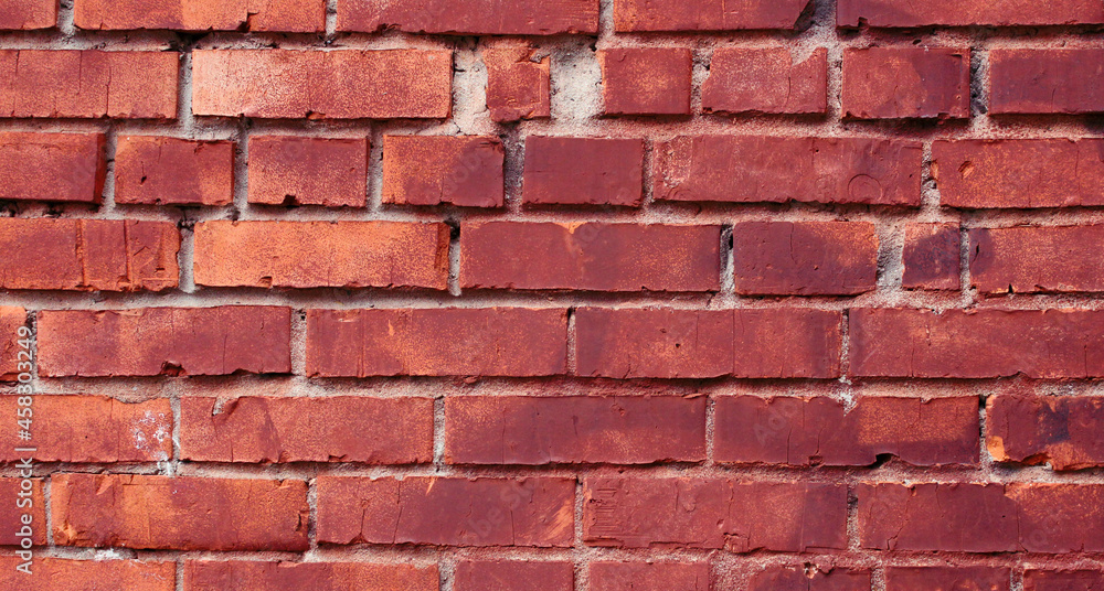 Obraz premium Red and orange brick old wall with defects