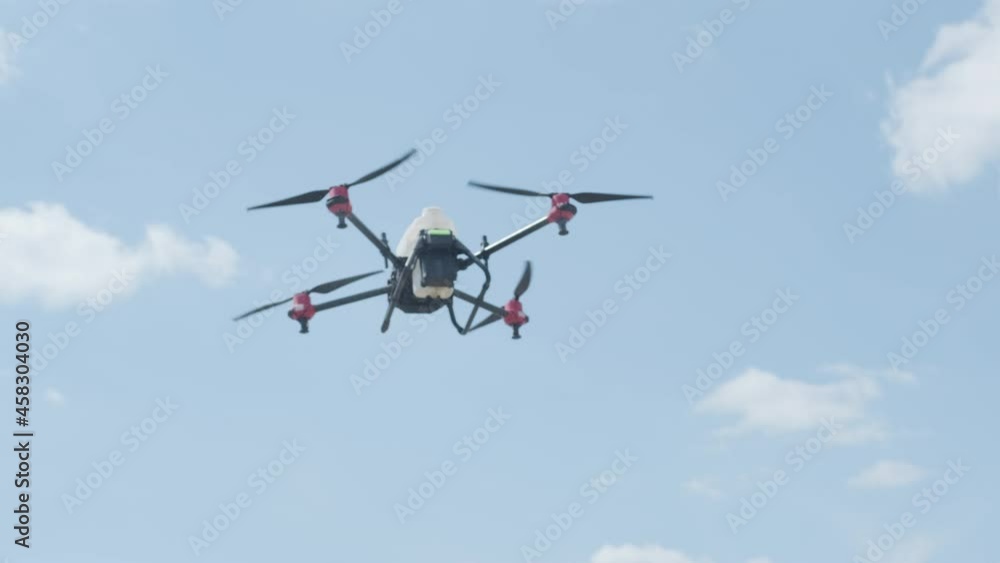 Professional drone with camera flying in the blue sky Professional drone with camera flying in the blue sky