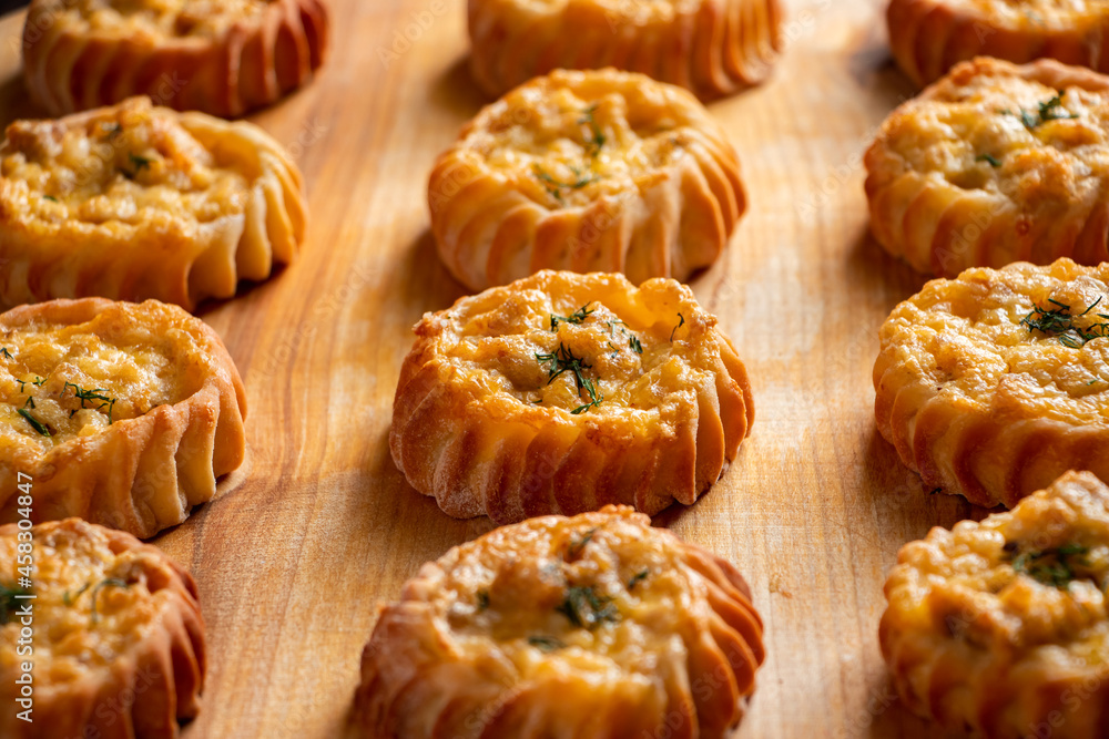 Muffins with vegetables and cheese on wooden board. Fresh homemade cakes for a healthy diet. Preparation of seasonal fall food. Muffins with vegetables and cheese on wooden board. Fresh homemade cakes for a healthy diet. Preparation of seasonal fall food.