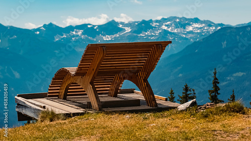 Beautiful alpine summer view with a wooden bench at the famous Rossbrand summit near Filzmoos, Salzburg, Austria photo