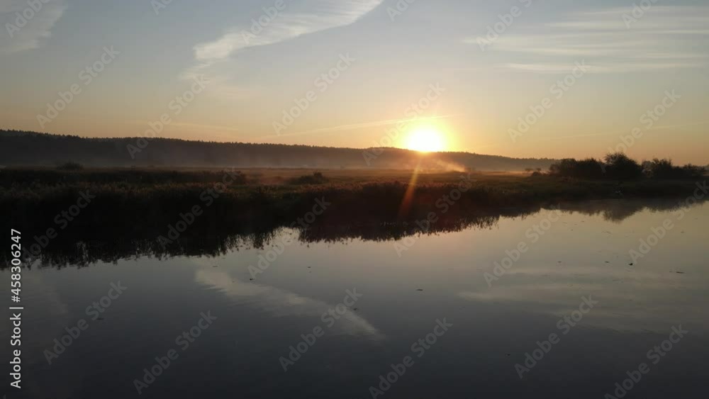 Sunrise over the river and the town of Suprasl.View from the drone over the river ,the lagoon,the surrounding fields,meadows and forests. Sunrise over the river and the town of Suprasl.View from the drone over the river ,the lagoon,the surrounding fields,meadows and forests.