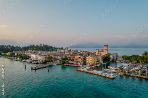 Aerial panoramic view of Sirmione city old town on lake Garda in Lombardy  Italy. Evening photo with a castle in a center