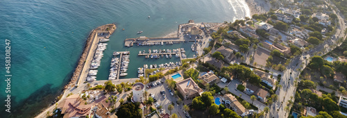 Panoramic wide image drone point of view Cabo Roig harbour with moored docked luxury nautical vessel in Mediterranean Sea bay. Travel and tourism concept. Province of Alicante, Costa Blanca, Spain 