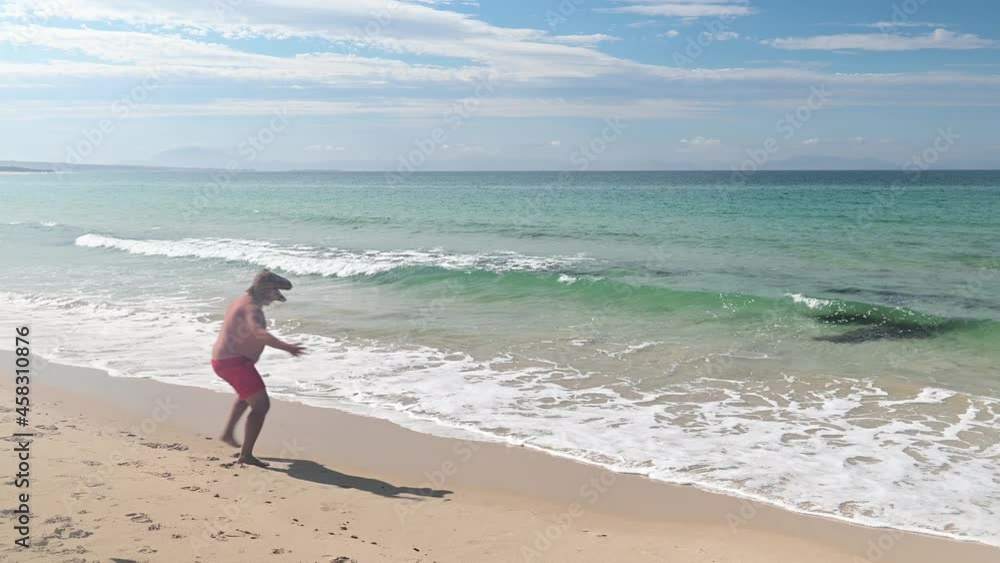 Man wearing euphoric lizard mask on beach Man wearing euphoric lizard mask on beach