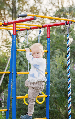 little boy on playground on summer day