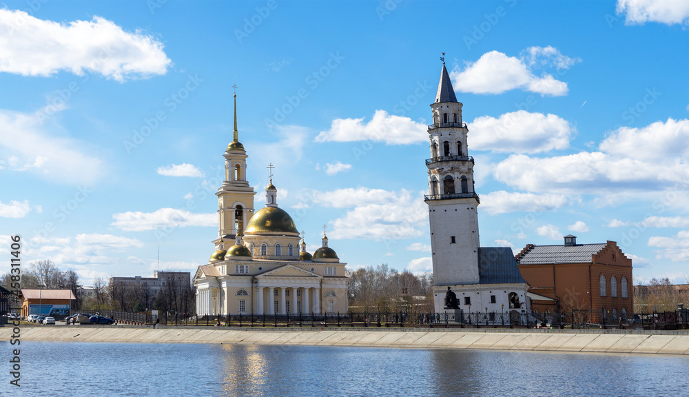 Leaning Tower of Nevyansk and Old Believers' church (domed) in spring day on the shore of the pond in Sverdlovsk Oblast, Russia Leaning Tower of Nevyansk and Old Believers' church (domed) in spring day on the shore of the pond in Sverdlovsk Oblast, Russia