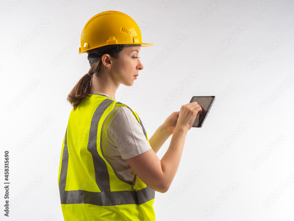builder works in tablet. Engineer with electronic tablet. Concept - she has construction drawings in her device. Portrait of builder on white background. Architect engineer in yellow helmet. builder works in tablet. Engineer with electronic tablet. Concept - she has construction drawings in her device. Portrait of builder on white background. Architect engineer in yellow helmet.