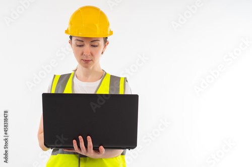 Woman builder with laptop. ...
