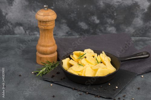 Potatoes in a pan with rosmarine, pepper and olive oil photo