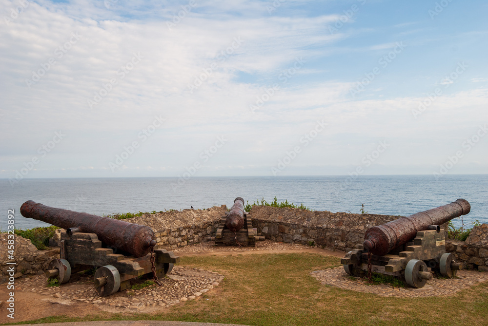 Three ancient cannons aimed at the sea