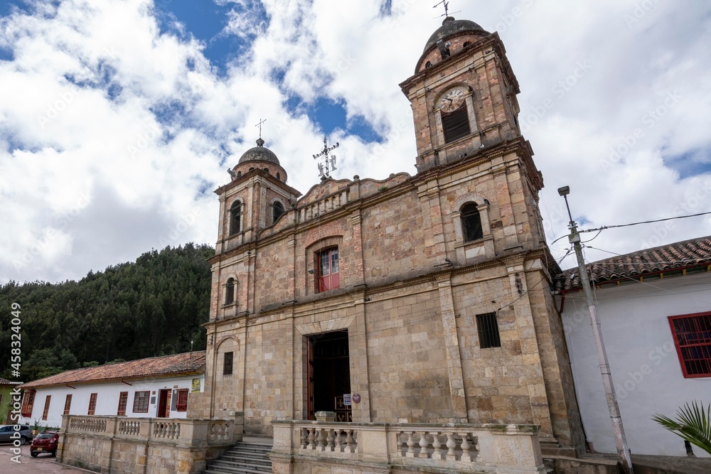 Nemocon, Cundinamarca, Colombia. July 2, 2021: Facade of San Francisco de Asís church and blue sky.