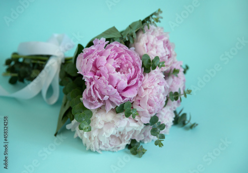 bouquet of pink peonies on a blue background
