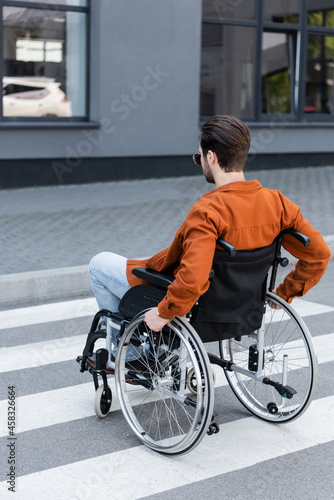 handicapped man moving on crosswalk in wheelchair © LIGHTFIELD STUDIOS